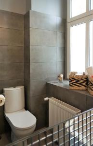 a bathroom with a toilet and a window at Explorer B&B Old Town Rooms & Apartment #don't be a tourist, be an Explorer! in Poznań +110 photos