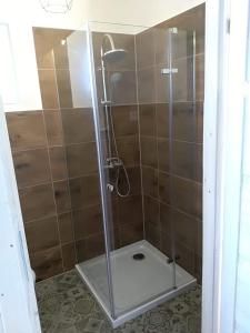 a shower with a glass door in a bathroom at Domki na górce in Kołczewo +36 photos