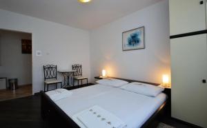 Postel nebo postele na pokoji v ubytování Apartman Dinka
