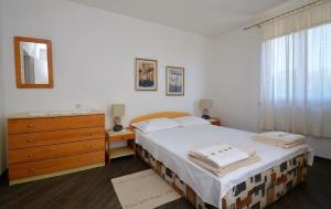 Postel nebo postele na pokoji v ubytování Apartman Dinka