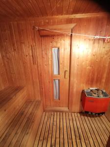 a wooden room with a door in a sauna at Ørterstølen Hytter in Gol