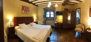 a bedroom with a large bed and a large window at Casa Rural Zigako Etxezuria in Ziga