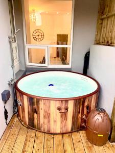 a hot tub in a room with a window at Victory luxury hot tub house in Blackpool
