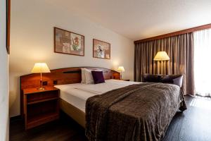 Postel nebo postele na pokoji v ubytování Hotel Münchwilen