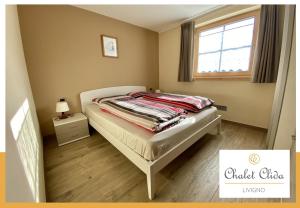 a small bedroom with a bed and a window at Chalet Clida in Livigno