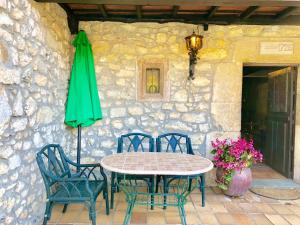a table and chairs and a green umbrella on a patio at Gran Pedroso de Llanes in Llanes +36 photos