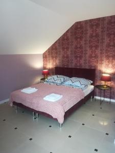 a bedroom with a large bed and two tables at Apart-noclegi in Siemiatycze