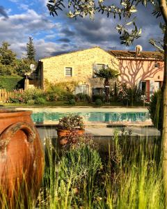 a house with a swimming pool in front of a house at Gites Lydil in Nyons