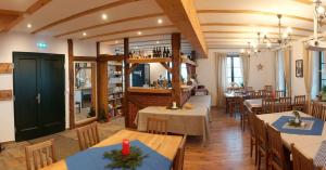 a restaurant with tables and chairs and a library at Berghäusel in Löbau