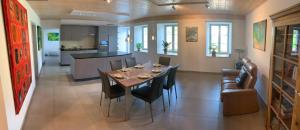 a dining room and kitchen with a table and chairs at Maison SANS SOUCI in Lajoux