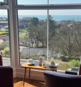 a table in front of a window with a view at Apartment Chic in Barmouth