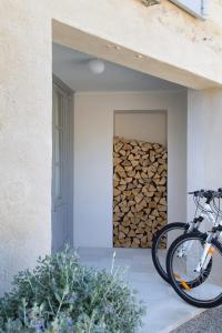 a bike parked next to a pile of fire wood at Villa Vagabonde in Gordes
