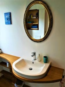 a bathroom with a sink and a mirror at Himmelreich - Über den Dächern der Altstadt in Witzenhausen