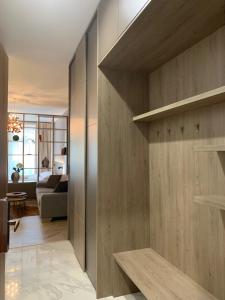 a room with wooden walls and a living room at Hrebienok 2 Apartman D109 in Smokovce