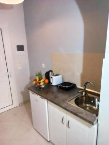 a kitchen with a sink and a counter top at Thalassa apartments in Marathias
