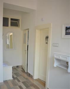 a room with white walls and a hallway with a mirror at Apartmány Pod vodárenskou věží in Poděbrady