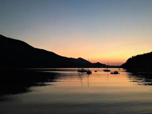 a group of boats on a lake at sunset at Casa Bicicletta in Fuschl am See