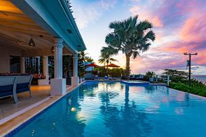 a swimming pool with a view of the ocean at Villa Northwinds - At Orange Hill - Private Pool in Nassau