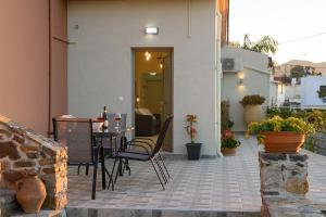 a patio with a table and chairs on a building at Aphrodite Mountain View in Périon