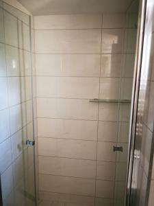 a bathroom with a shower with a glass door at Wójtówka 16 in Lądek-Zdrój