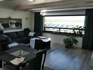 a living room with a couch and a table at Apartamenty Just in Charzykowy