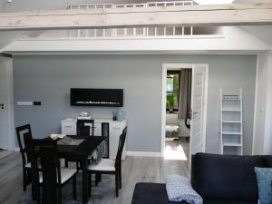 a living room with a table and a couch at Apartamenty Just in Charzykowy