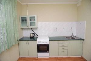 a small kitchen with a stove and a sink at ул. Героев Днепра 5, рядом Днепр in Cherkasy +3 photos