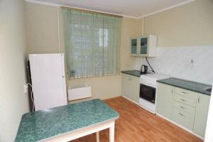 a kitchen with a white refrigerator and a green counter top at ул. Героев Днепра 5, рядом Днепр in Cherkasy