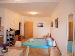 a bedroom with a blue bed in a room at Apartments Skorin in Lumbarda