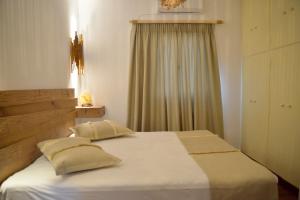 a bedroom with a bed with two pillows on it at Esperos Seaside Suite in Adamas, Milos in Adamantas