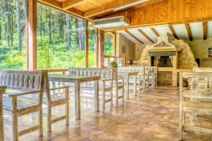 a dining room with tables and chairs and a fireplace at Крушун - Единствена на метри от водопадите, Krushun - The only stay just meters from the waterfalls in Krushuna