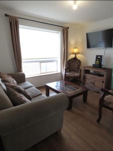 a living room with a couch and a coffee table at Greyhouse in Puerto Natales