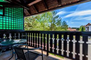 a balcony with a table and chairs and a view at Apartment Vila Simovic in Zlatibor