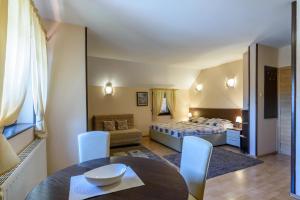 a bedroom with a bed and a table and chairs at Apartment Vila Simovic in Zlatibor