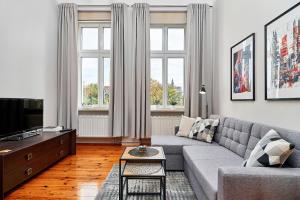 a living room with a couch and a tv at Apartament Nowa 12 in Wrocław
