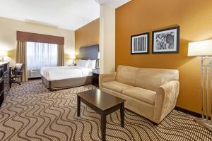 a hotel room with a couch and a bed at La Quinta by Wyndham South Bend in South Bend +46 photos