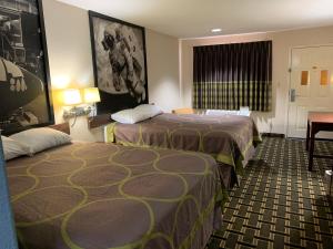 a hotel room with two beds and a window at Super 8 by Wyndham Baytown I-10 in Baytown +27 photos