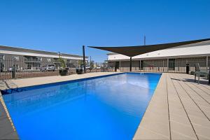 a large swimming pool in front of a building at Quest Whyalla in Whyalla