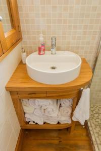 a bathroom with a sink and some towels at Elliott Street Gem in Nelson