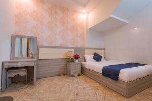 Postel nebo postele na pokoji v ubytování Khanh Uyen 1 Hotel