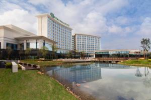 a hotel building with a pond in front of it at Holiday Inn Nanyang by IHG in Nanyang