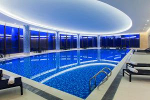 a large swimming pool in a building at Holiday Inn Nanyang by IHG in Nanyang