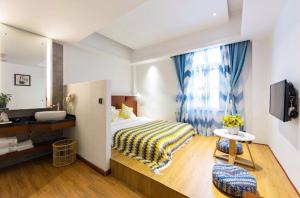 a bedroom with a bed and a large window at Four Seasons Are Picturesque Guesthouse in Zhangjiajie