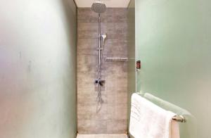 a bathroom with a shower with a glass door at Four Seasons Are Picturesque Guesthouse in Zhangjiajie