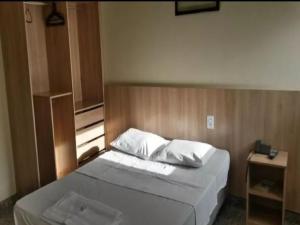 a bedroom with a large bed with a window at OYO Hotel Ana Cassia in Manaus