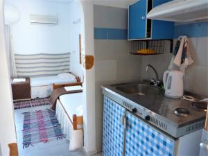 a small kitchen with a sink and a bunk bed at Chios Panorama in Karfas