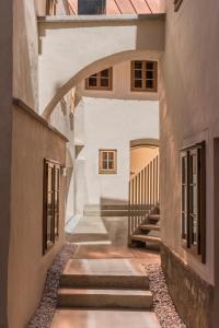 an alleyway between two buildings with a staircase at Kai 36 - Hotel zwischen Fels und Fluss in Graz