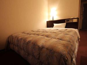 Säng eller sängar i ett rum på Hotel Welcome Matsumoto