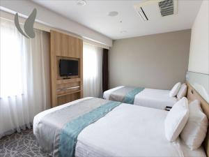 Postel nebo postele na pokoji v ubytování Almont Hotel Naha Omoromachi + 90 fotografií