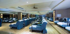 a row of blue chairs in a waiting room at Zhuhai Palm Spring Hotel in Zhuhai